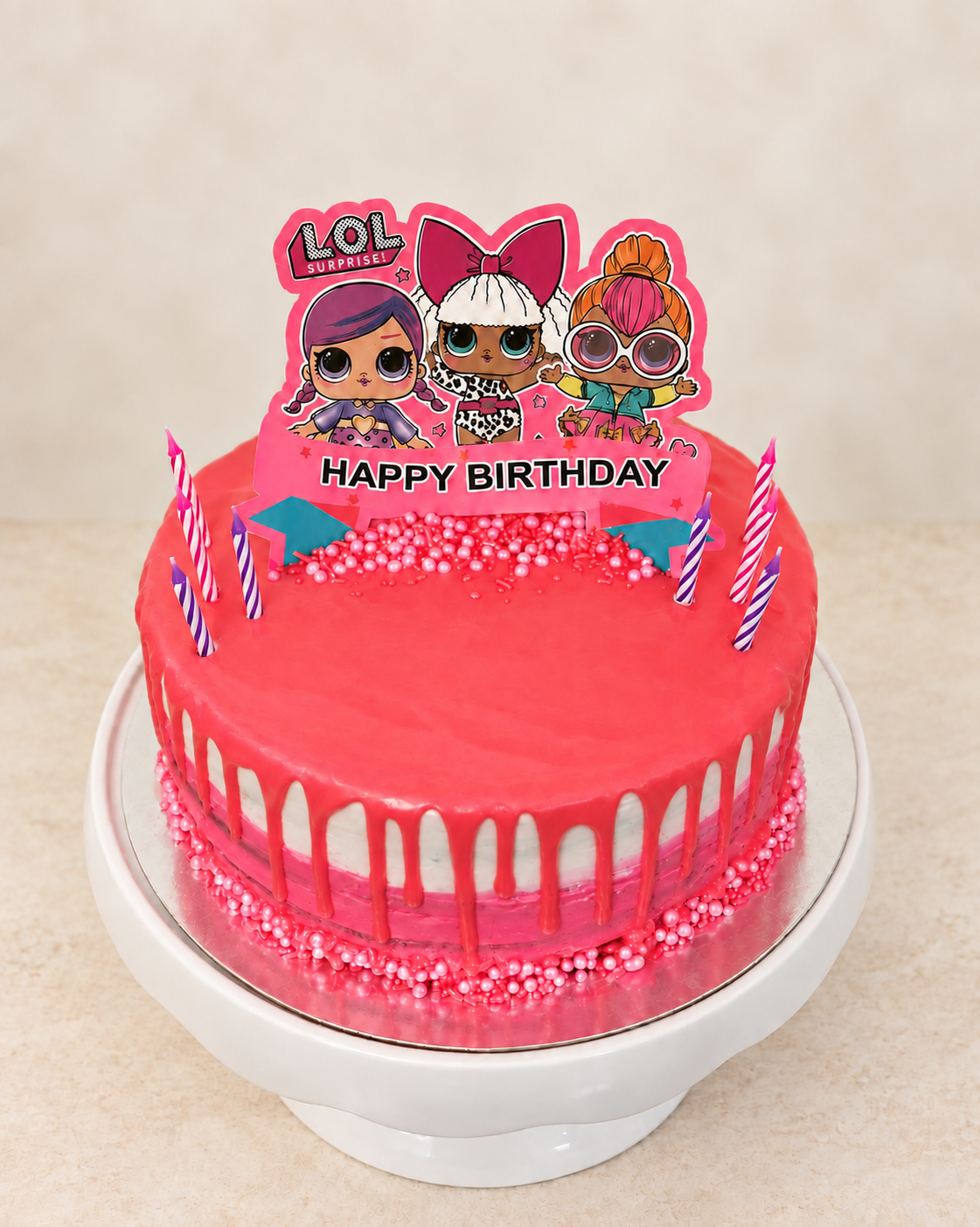 Pink custom themed birthday cake with a polished drip, sprinkles, candles, and a character topper