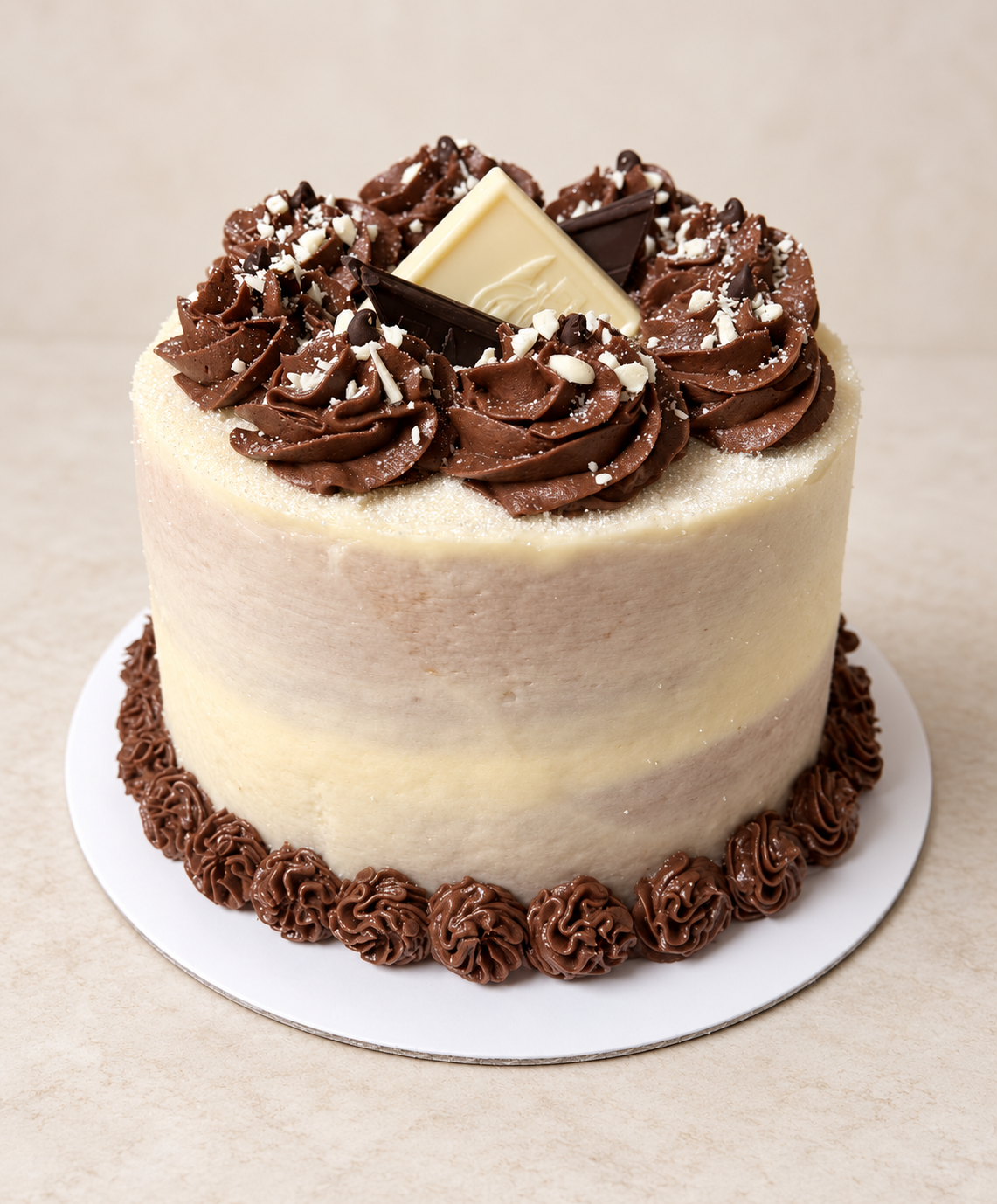 White Chocolate Mocha cake with chocolate rosettes and white and dark chocolate pieces